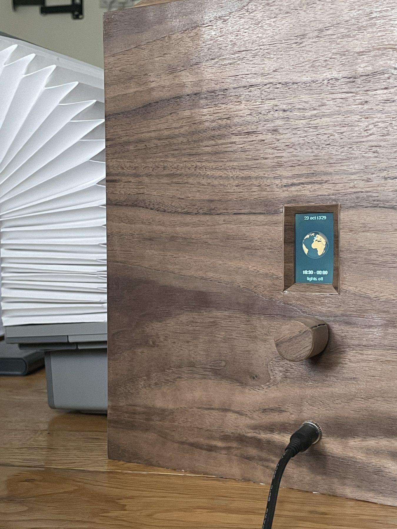 Kumi: walnut shell and folded paper bellow
